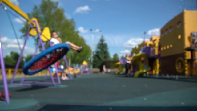 Defocused summer children playground with kids and parents. HD 1080 fast motion