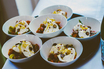 delicious buratta dish with cherry tomato basil jalapeno and lemon - luxurious wedding catering dish