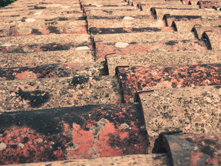 Pattern of old red tiles closeup on roof