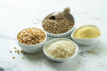 Assorted grains in the white bowls