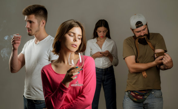 Stop alcohol addiction. Addictive group including alcohol cigarettes and drugs. Hard drugs and alcohol addict. Serious sad woman having alcohol addiction.