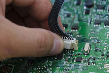 Quality control and assembly of SMT printed components on circuit board in QC lab of PCB manufacturing high-tech factory