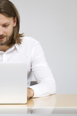 Young man working on laptop in the office