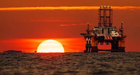 drilling platform on the ocean during sunrise