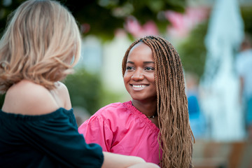 Fototapeta premium Happy female friends hanging out in the city, multiracial group of people