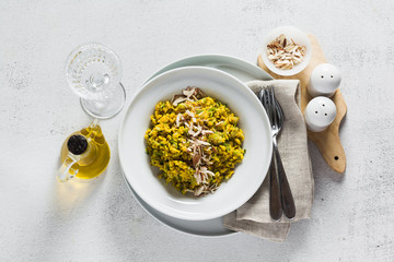risotto with zucchini and turmeric or saffron in a plate on the table. healthy italian food