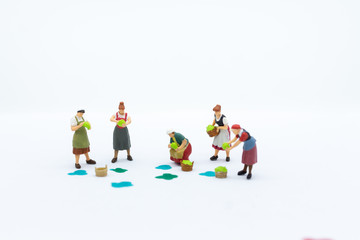 Fototapeta premium Miniature people: Gardeners and the results of agriculture, vegetables. Image use for distribution to the market.
