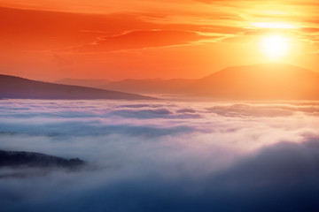 Colorful landscape in mountains with fog and sun