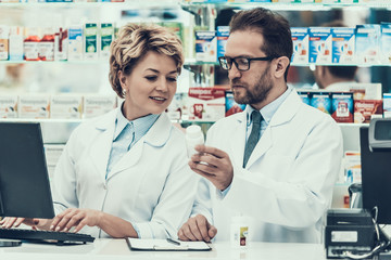 Female and Male Pharmacist Working in Drugstore