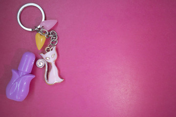 keychain with a pink cat on a red background, copy space, a place for advertising