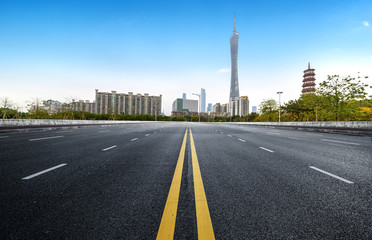 Fototapeta na wymiar Empty road floor surface with modern city landmark buildings of guangzhou bund Skyline
