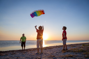 kids launching the rainbow kite together