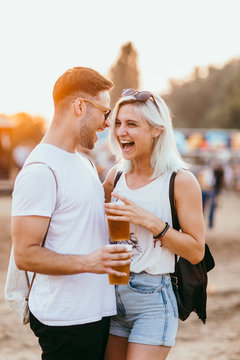 Young couple at the music festival having fun