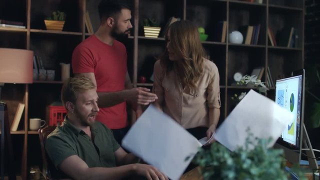 Furious woman boss checking financial report in office. Dissatisfied employee hitting hands on table during conflict with evil boss at office meeting. Emotional woman screaming at man