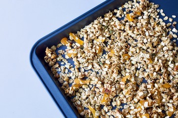 Tasty oat granola on the baking sheet.