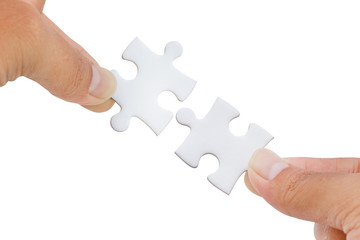 hands trying to connect jigsaw puzzle piece isolated on white background - clipping paths
