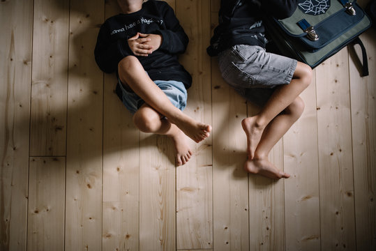 Fr&egrave;res qui jouent par terre dans leur chambre
