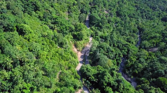 Aerial View of Road across Tropical Forest in Thailand