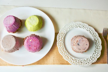  Tasty colourful cashew cupcake on the white plate