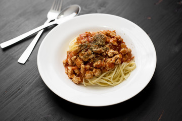 Spaghetti on black wooden background