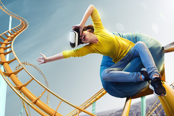 Young woman used Virtual reality helmet VR. She see Roller-coaster park