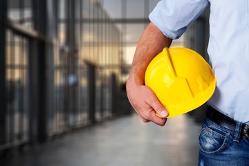 Worker man with helmet on background