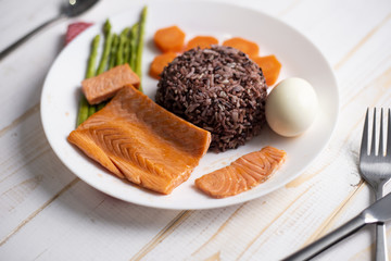 Health food concept, salmon with rice and vegetable on wood background