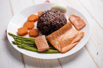 Health food concept, salmon with rice and vegetable on wood background