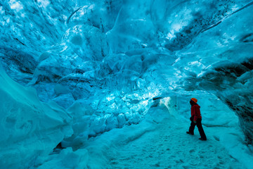 explorer inside an ice cave, vatnajokull national park, Iceland