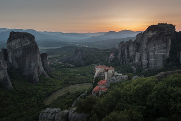 Fototapeta na wymiar Meteors or Meteora with Orthodox Monasteries, panoramic view from the plateau to the valley of Thessaly
