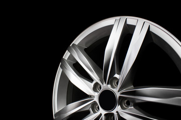 Aluminum metal wheel rim texture. Car alloy wheel, isolated on black background.
