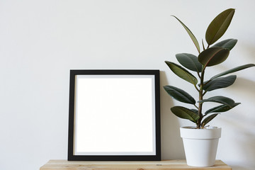 Posters square format in black frame in white stylish modern interior on shelf, living room. Design template mockup.