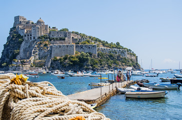 Ancient castle near Ischia island. Tourist target when traveling in Campania. - obrazy, fototapety, plakaty