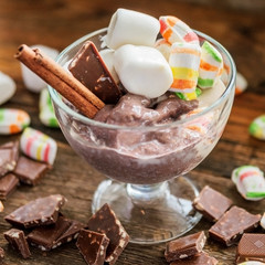 Chocolate Nice cream on wooden background, copy space. Homemade vegan - healthy summer dessert.