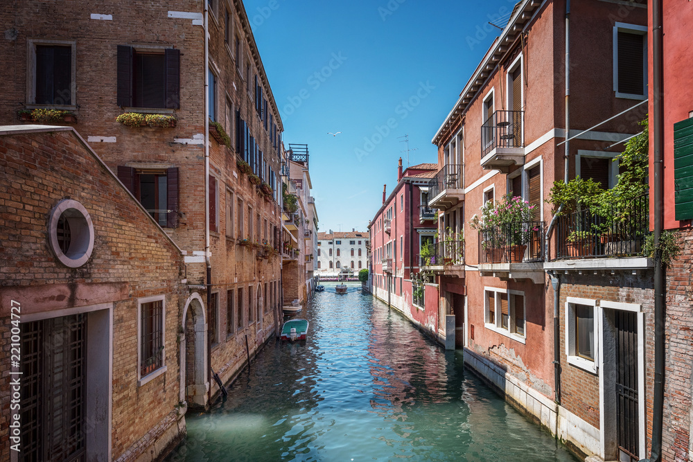 Wall mural Traditional canal street and colorful Venetian houses in Venice, Italy.