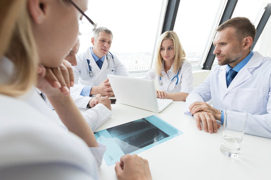Group of doctors discuss x-ray