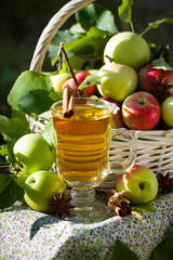 Basket with apples cider juice or vinegar in glass