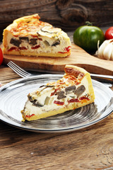 Homemade Cheesy Egg Quiche for Brunch with Spinach and Tomato, onions and zucchini.