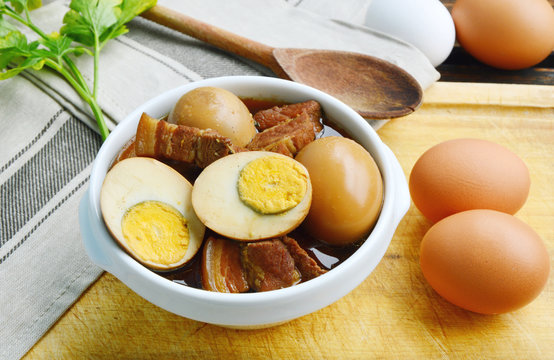 Thai Egg Menu.
Eggs Stewed or Thai name is khai phalo muu saam chan on wooden background.