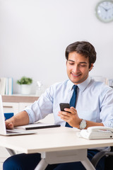 Young handsome businessman working in office