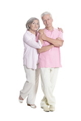 portrait of senior couple embracing on white background