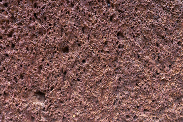 background of red laterite stone wall texture