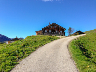 Fototapeta na wymiar Alpen Haus blauer Himmel 