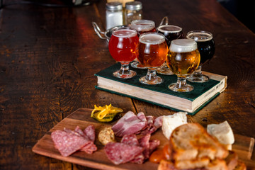 A Flight Of Beer With A Plate Of Pub Food