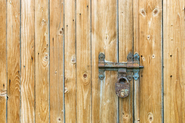 wooden gate with hinged hinges and padlock
