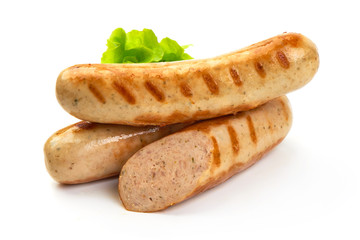 Grilled Munich sausages with green lettuce, isolated on white background.