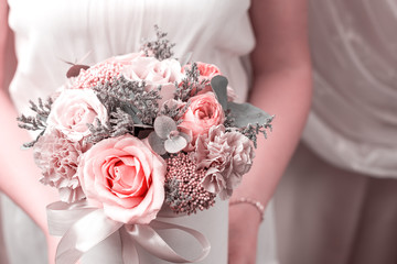 A girl in a white dress is holding a round box with flowers - congratulation, holiday