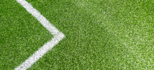 Green synthetic grass soccer sports field with white corner stripe line