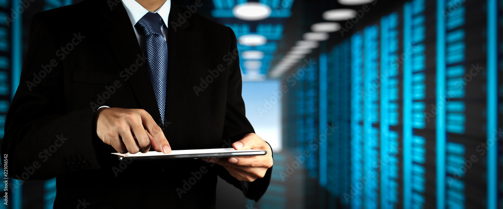 Poster Businessman working with VR wide blank screen computer on server room in background.