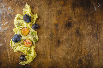 Plums on wooden background